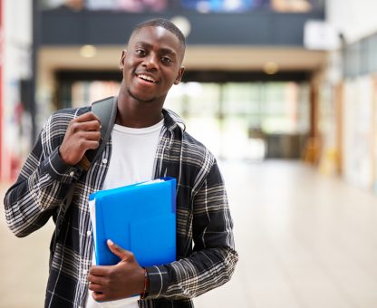 Portrait,Of,Male,Student,Standing,In,College,Building